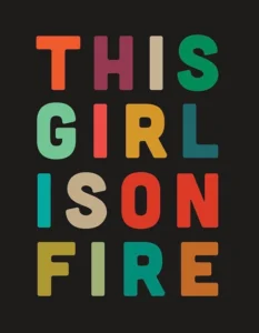 Zwarte poster met de tekst This girl is on fire in vrolijke kleuren